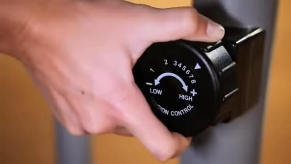 magnetic resistnace dial woman selecting resistance strength