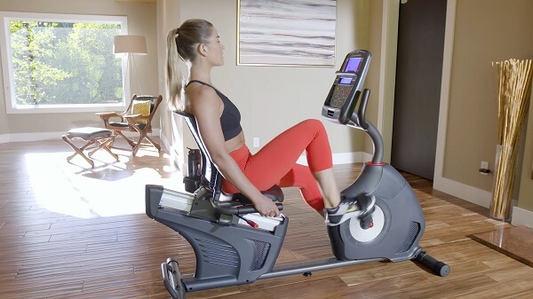 side view of woman pedaling on scwhinn 270 recumbent bike