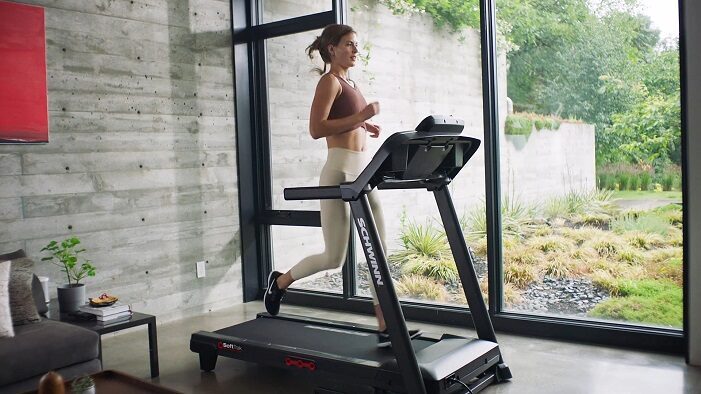 Schwinn 810 Treadmill with shcwinn app woman running on schwinn 810 treadmill in her home