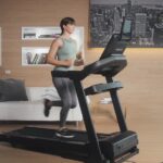 woman running on Sole F63 treadmill side view