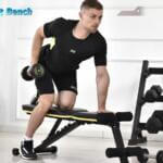 man performing dumbell rows on teclor weight bench