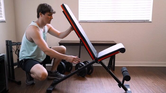 man adjusting the linodi weight bench backpad