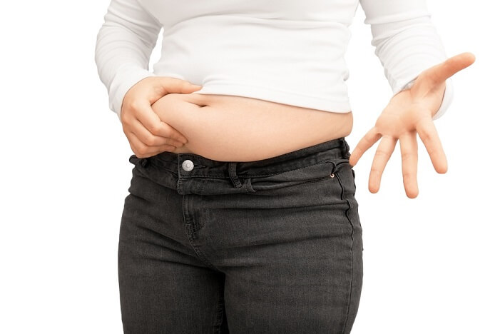 woman pinching belly fat