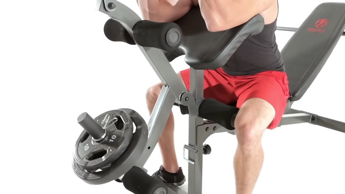 marcy md-857 preacher curl attachments man performing preacher curls on marcy md-857 bench
